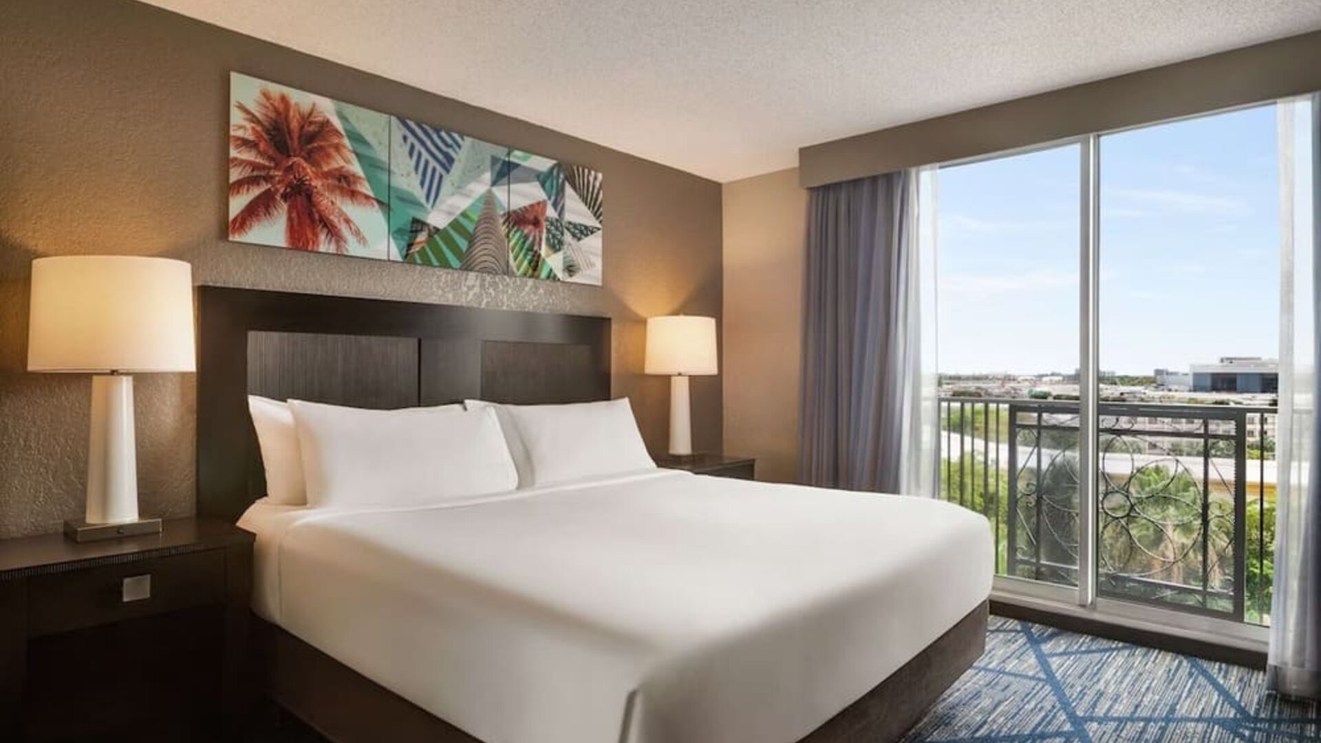 Day use room with large windows, king bed and private bathroom at Embassy Suites By Hilton Miami - International Airport.