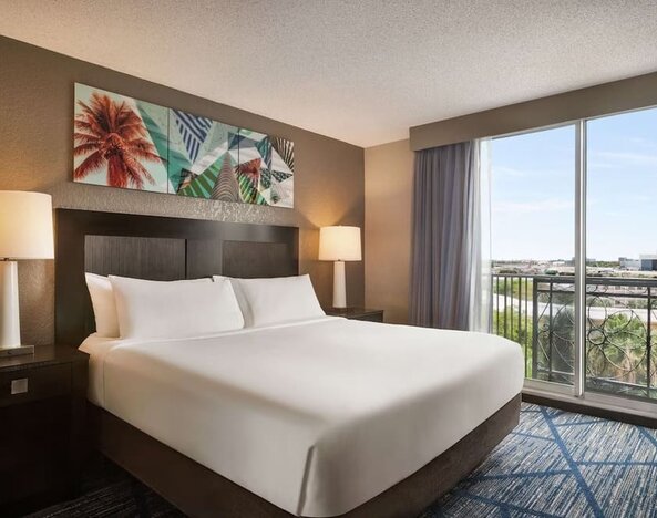 Day use room with large windows, king bed and private bathroom at Embassy Suites By Hilton Miami - International Airport.