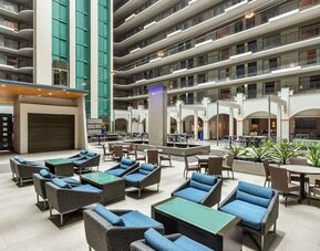 Lobby workspace with comfortable seating at Embassy Suites By Hilton Miami - International Airport.