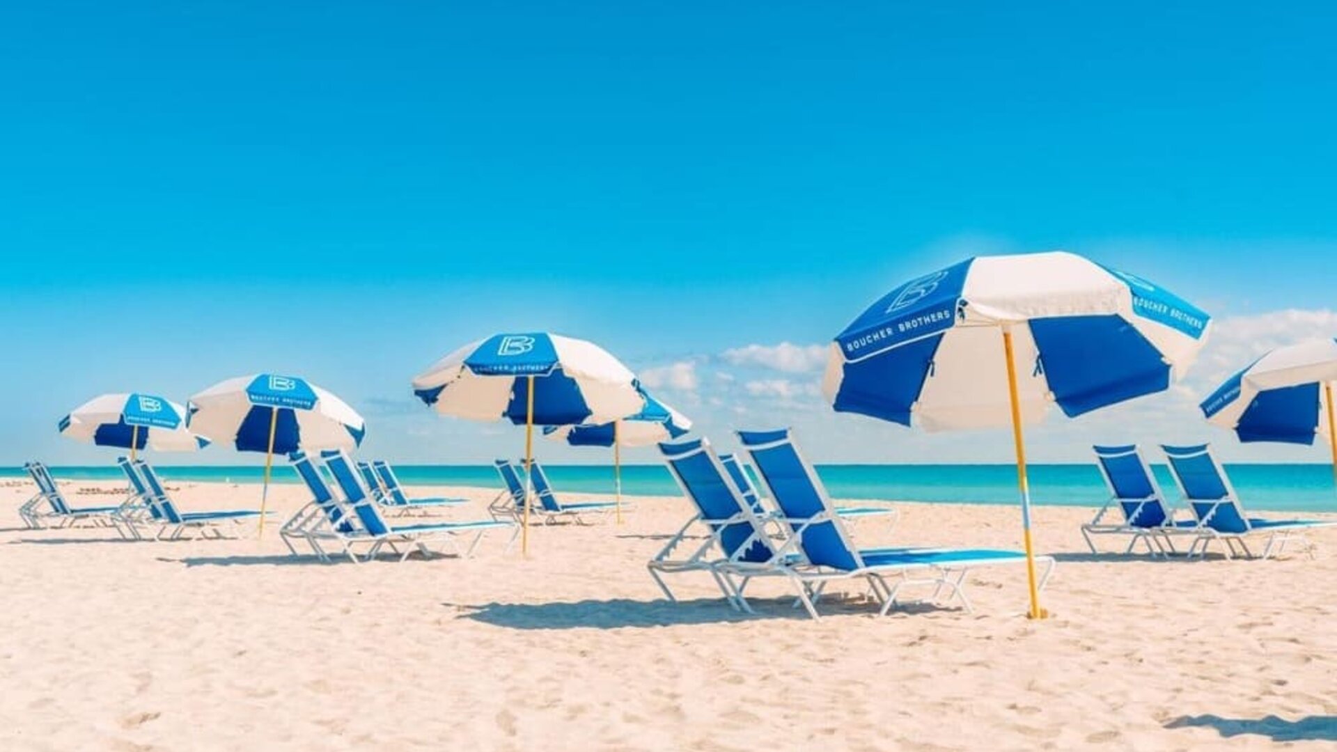 Beach access with lounge seating and umbrellas at The Goodtime Hotel.