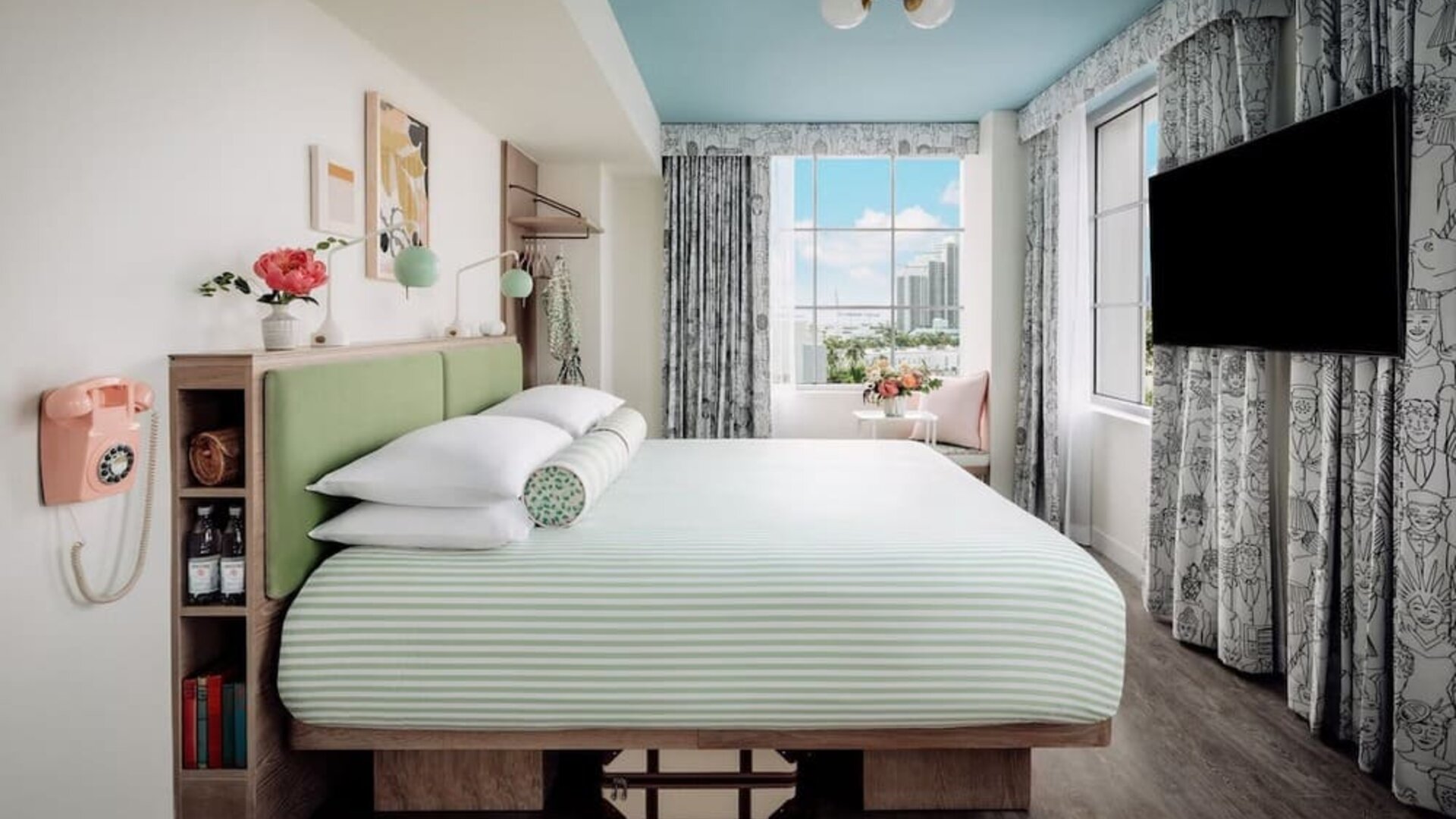 Day use room with king bed, TV screen, large windows and private bathroom at The Goodtime Hotel.