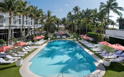Beautiful outdoor pool with lounge chairs at Cadillac Hotel & Beach Club, Autograph Collection.