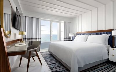 Day use room with king bed, large windows, work desk and private bathroom at Cadillac Hotel & Beach Club, Autograph Collection.