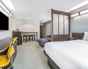 Day use room with TV and work desk at Microtel Inn And Suites By Wyndham Austin Airport.