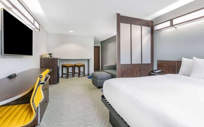 Day use room with TV and work desk at Microtel Inn And Suites By Wyndham Austin Airport.