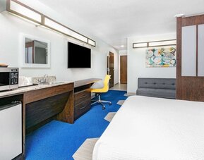 Day use room with TV and work desk at Microtel Inn And Suites By Wyndham Austin Airport.
