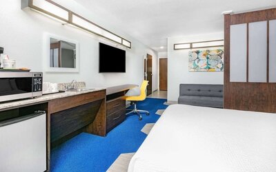Day use room with TV and work desk at Microtel Inn And Suites By Wyndham Austin Airport.