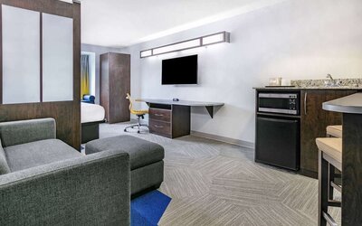Day use room with TV and work desk at Microtel Inn And Suites By Wyndham Austin Airport.