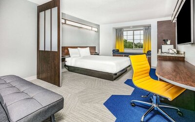 Day use room with TV and work desk at Microtel Inn And Suites By Wyndham Austin Airport.