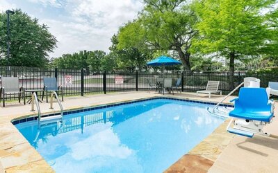 Outdoor pool at Microtel Inn And Suites By Wyndham Austin Airport.