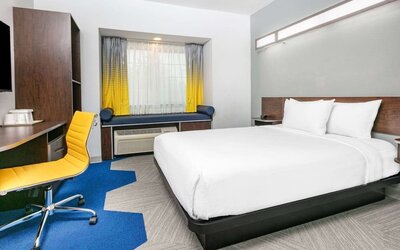 Day use room with TV and work desk at Microtel Inn And Suites By Wyndham Austin Airport.