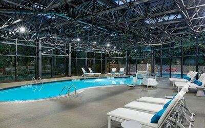 Indoor pool surrounded with loungers at Westin Atlanta Airport Hotel.