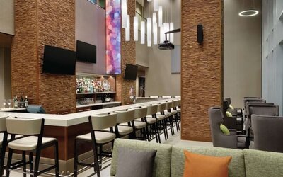 Hotel bar with ample seats at Hilton Garden Inn Calgary Downtown.