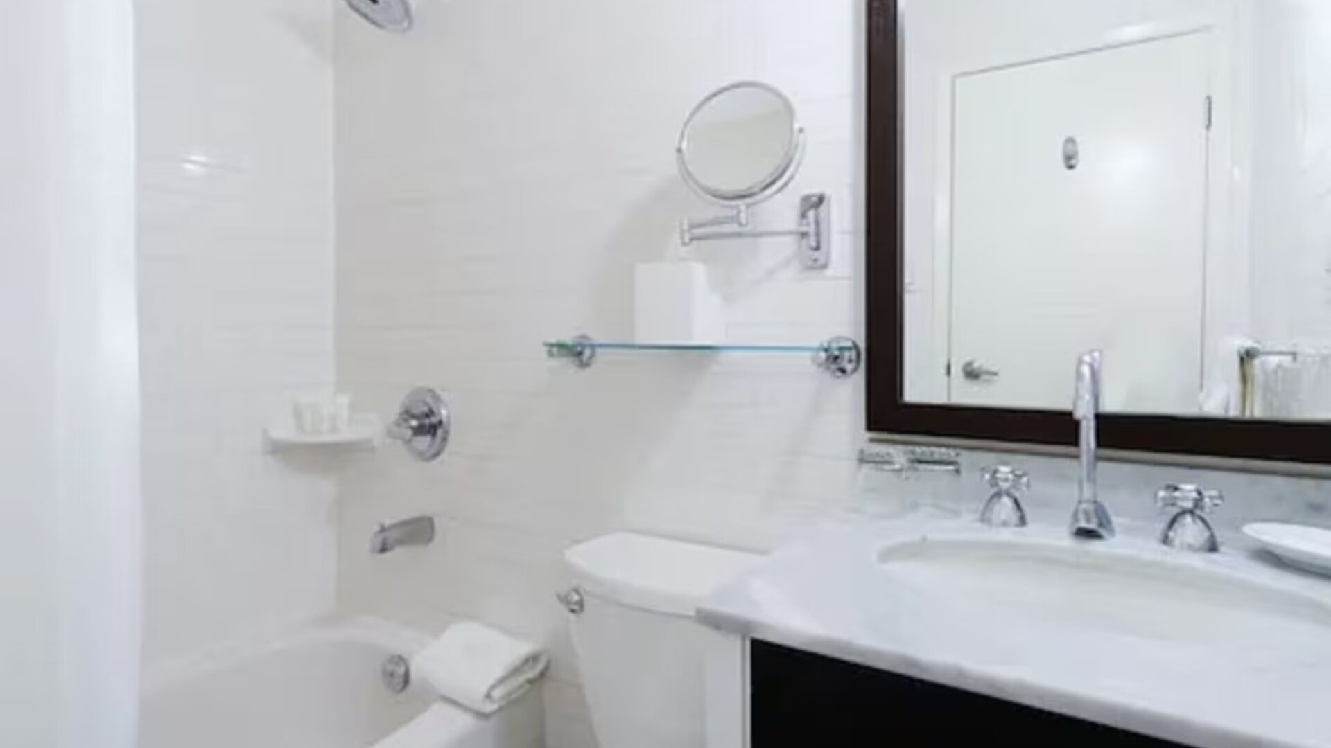 Guest bathroom with shower and tub at Arc The Hotel Ottawa.