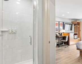 Guest bathroom at AmericInn By Wyndham Urbana.