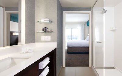 Private guest bathroom with shower and free toiletries at Residence Inn By Marriott LAX Airport.