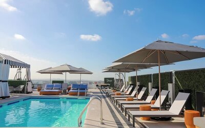 Relaxing outdoor pool with lounge chairs at Montrose At Beverly Hills.