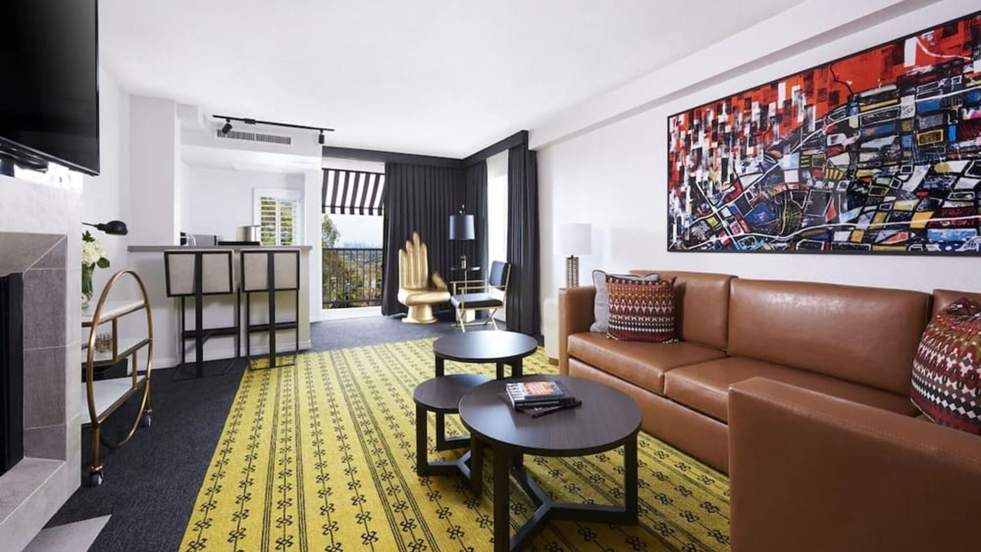 Day use suite with living area, fireplace, balcony and in-room kitchen at Montrose At Beverly Hills.