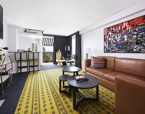 Day use suite with living area, fireplace, balcony and in-room kitchen at Montrose At Beverly Hills.