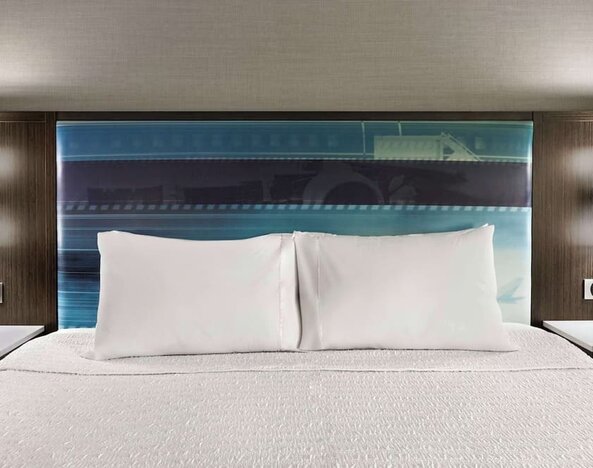 Comfortable king bed at Hampton Inn Chicago-O'Hare International Airport.