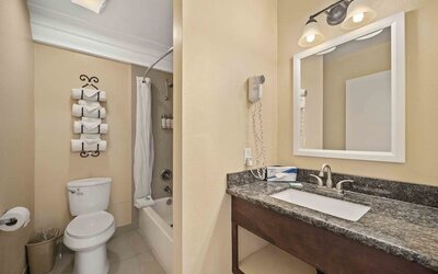 Guest bathroom at Lemon Tree Hotel & Suites Anaheim.