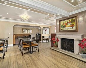 Lobby seating and restaurant at Lemon Tree Hotel & Suites Anaheim.