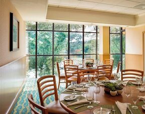 Dining area with natural light perfect for coworking at Boston Marriott Newton.