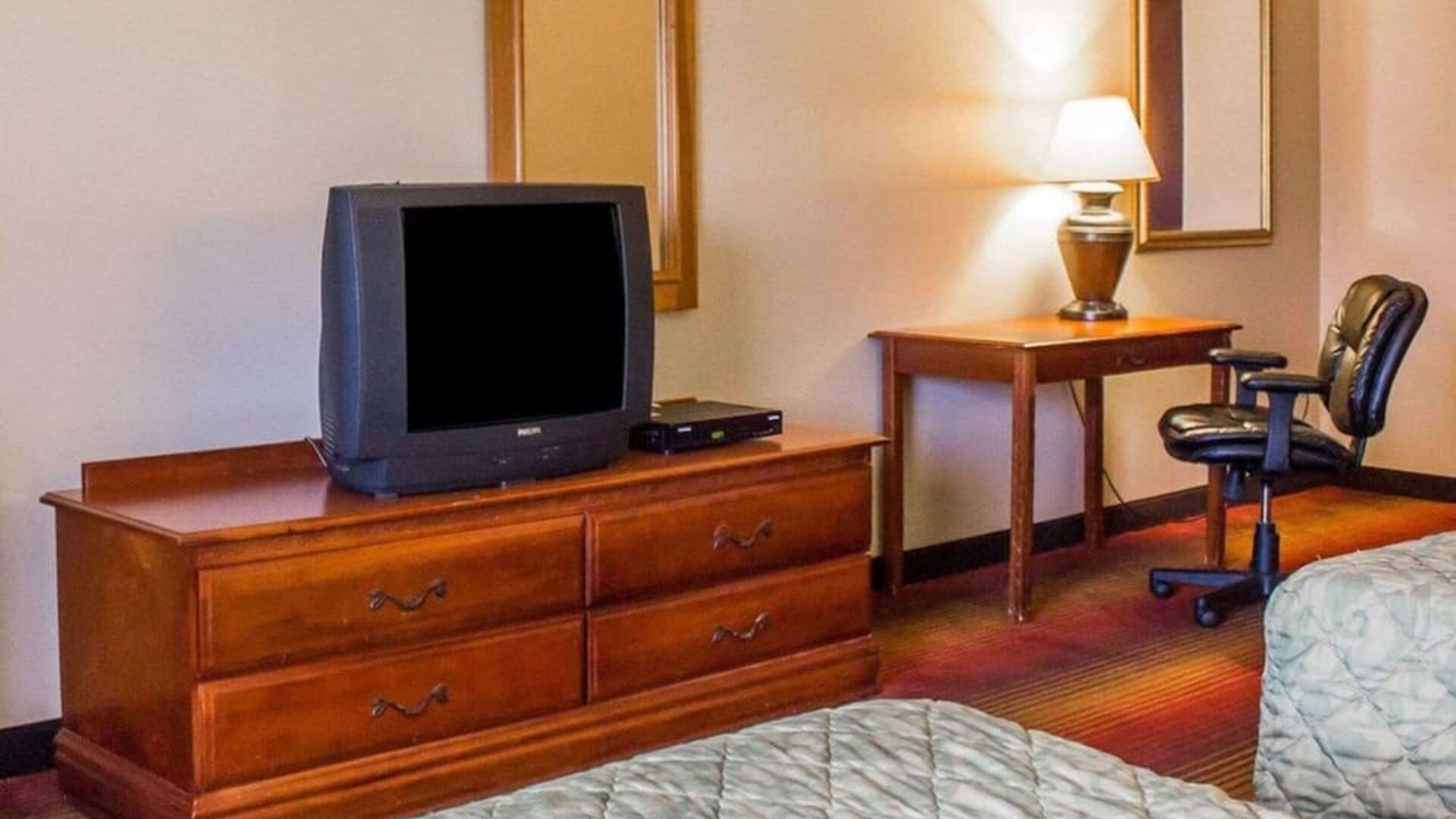Work table beside the TV inside day use room at Rodeway Inn Huntington Station.