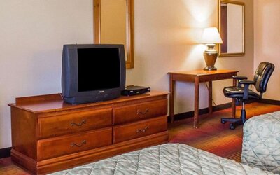 Work table beside the TV inside day use room at Rodeway Inn Huntington Station.