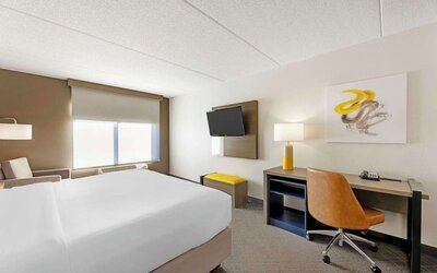 Work desk and TV inside day use room at Comfort Inn & Suites Arlington Heights - Schaumburg.