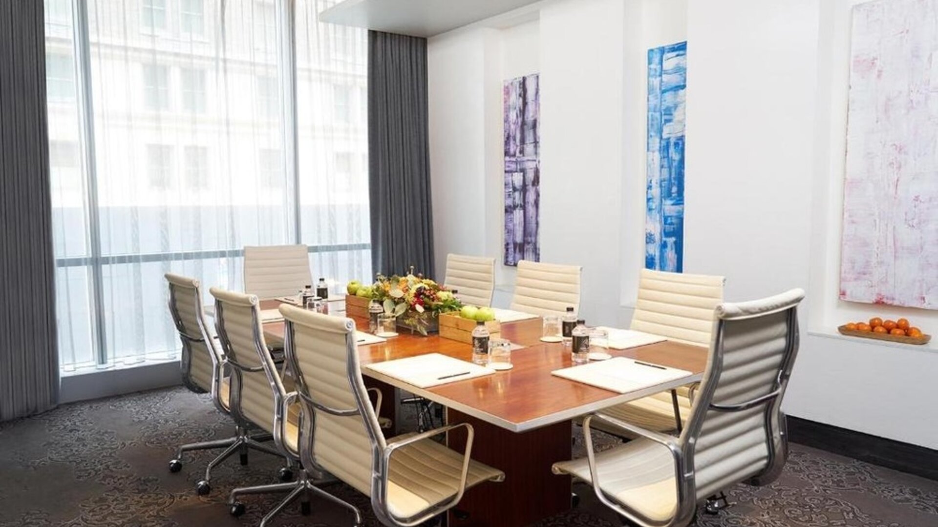 Professional meeting room with large table and ergonomic chairs at Hotel 48LEX New York.