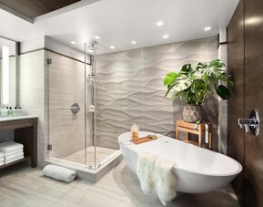 Private guest bathroom with combined shower and tub at Hotel 48LEX New York.
