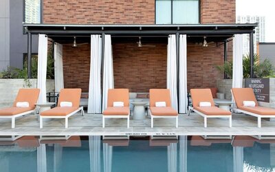 Outdoor pool and sun loungers at Canopy By Hilton Austin Downtown.