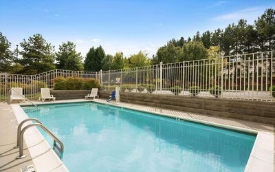 Outdoor pool at Country Inn & Suites By Radisson, Norcross, GA.