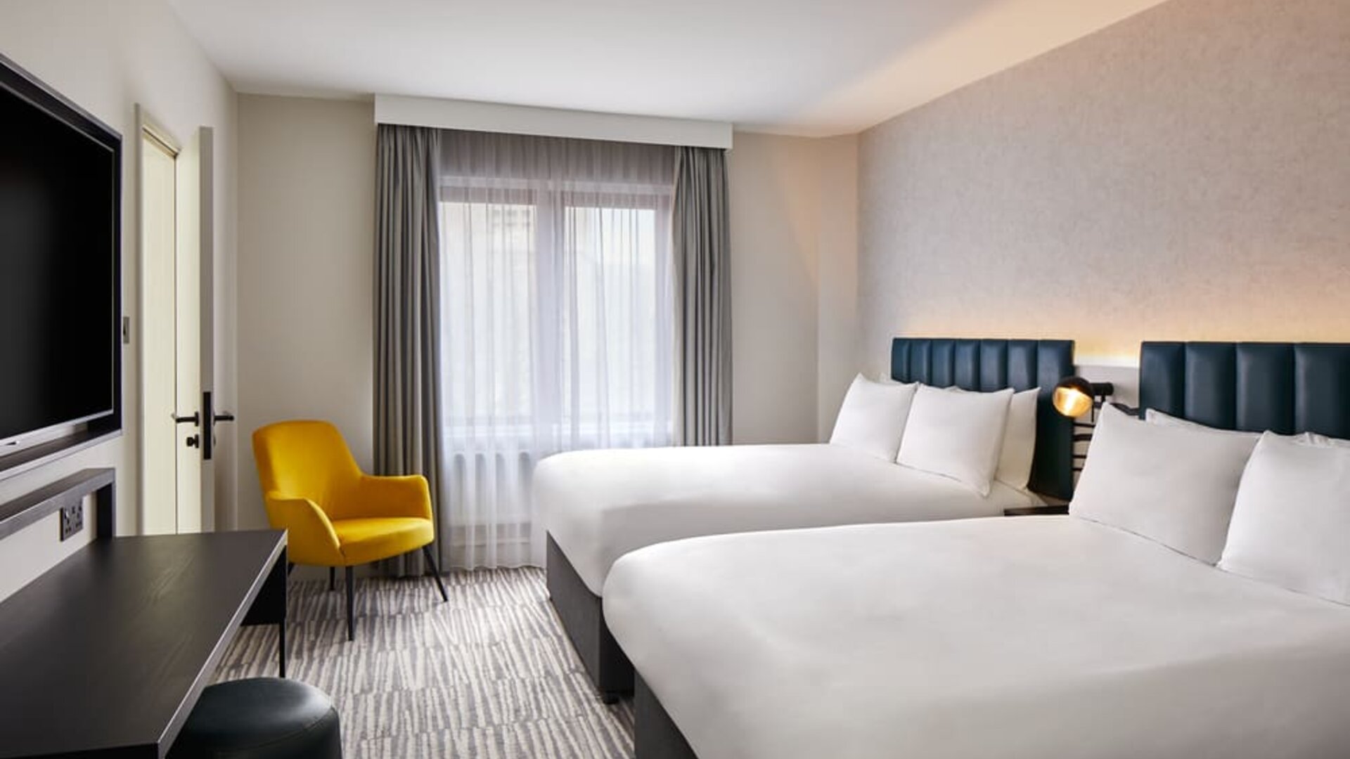 Two queen beds with TV at Leonardo Hotel Dublin Christchurch.