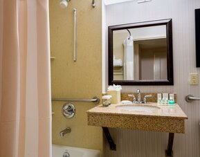 Bathroom at Hilton Garden Inn Tribeca with privacy curtains and plush towels.