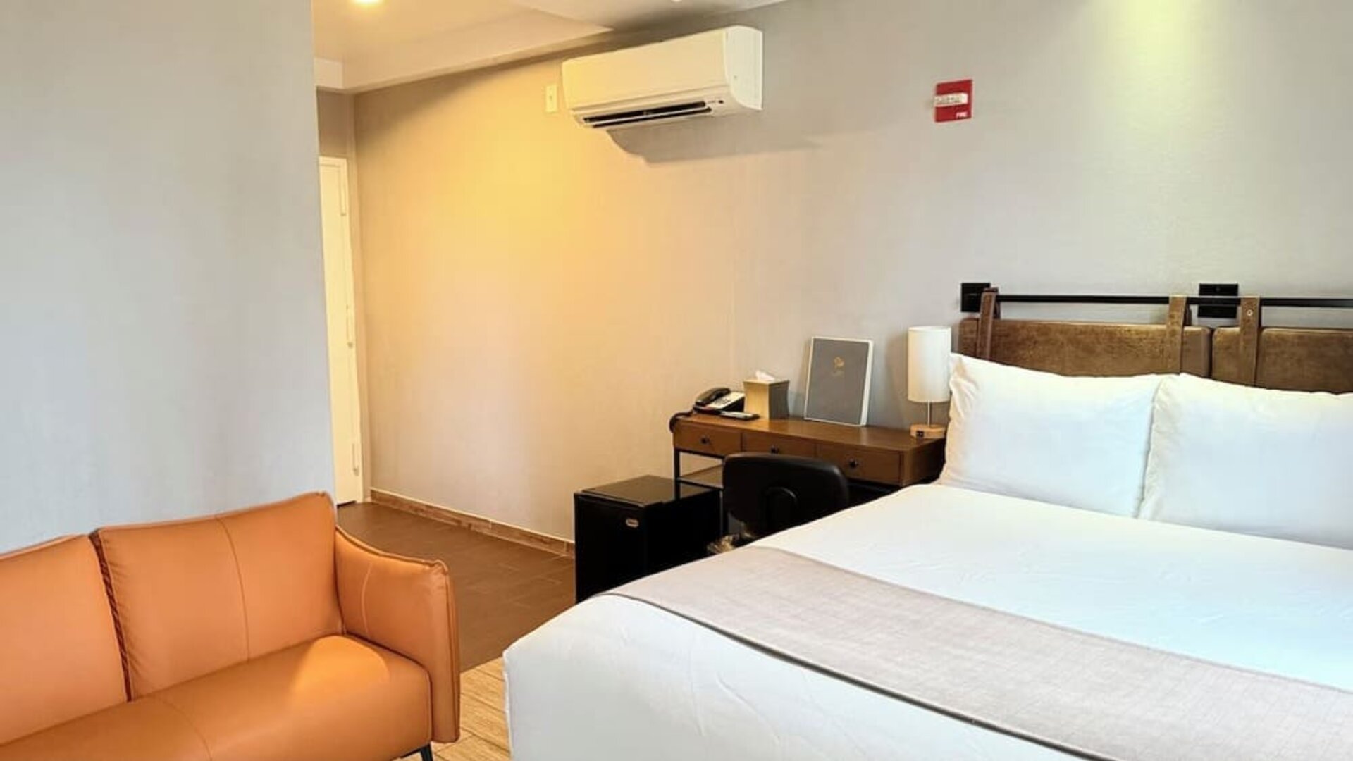 Madison LES Hotel room with double bed, and desk for working.