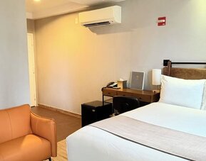 Madison LES Hotel room with double bed, and desk for working.