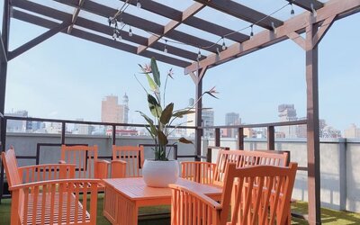 Outdoor terrace with table and chairs for relaxing/socializing.