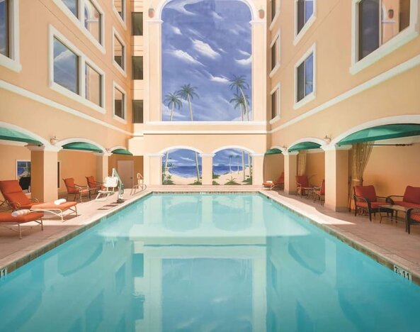 Relaxing large, outdoor pool with loungers at Hilton Los Angeles/San Gabriel.