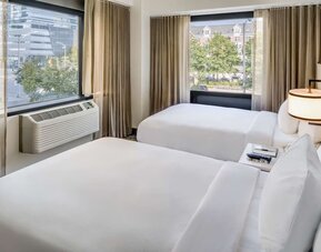 Comfortable day room at DoubleTree By Hilton Jersey City with natural light and beautiful views.