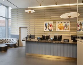 Reception area with comfortable seating at the Hilton Fashion District. 