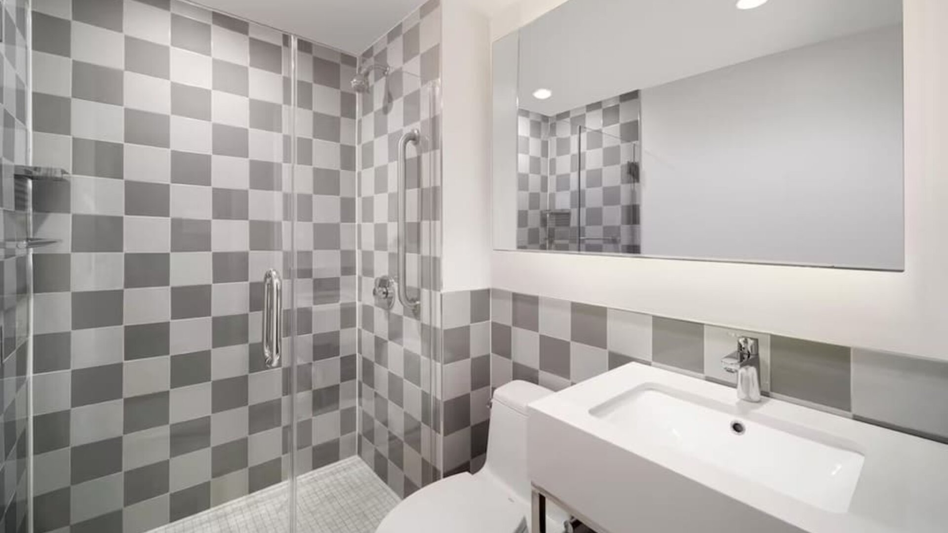Guest bathroom with shower at Best Western Premier Empire State Hotel.