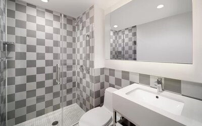 Guest bathroom with shower at Best Western Premier Empire State Hotel.