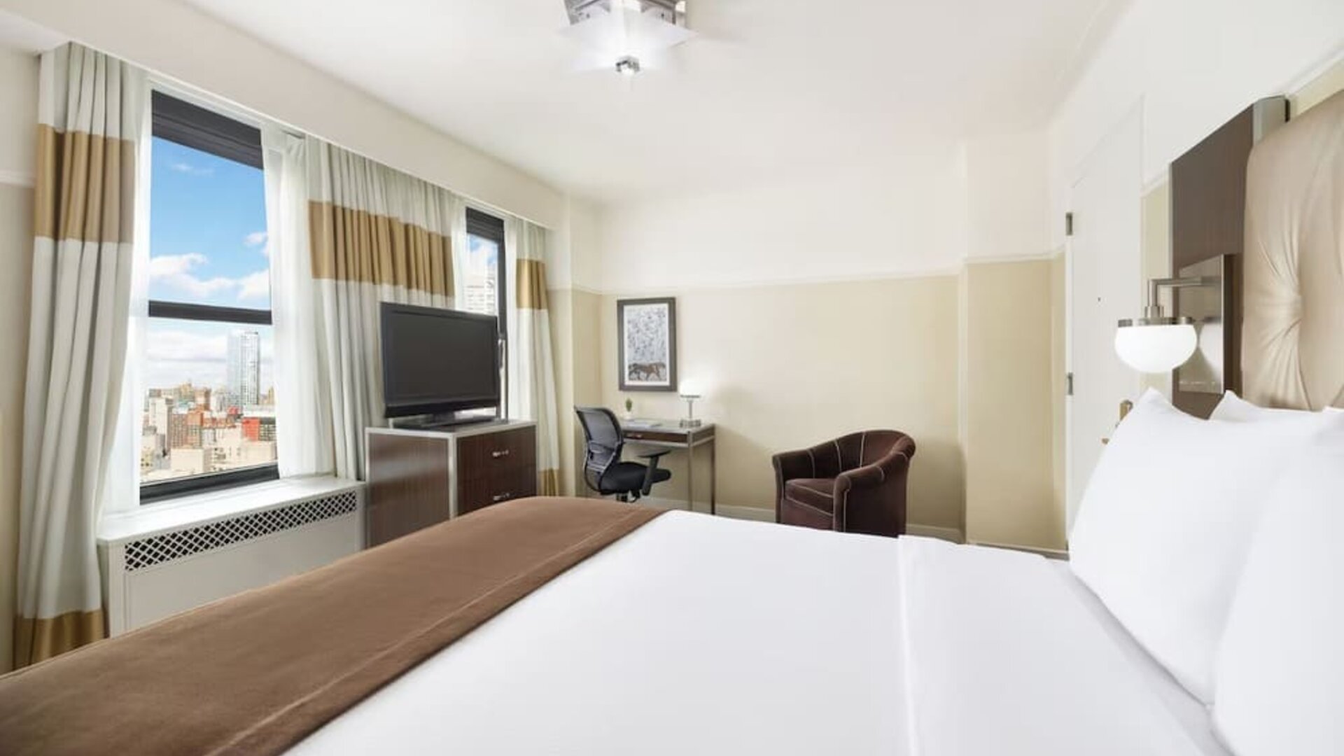 Day use room with work desk and natural light at New Yorker by Lotte Hotels.