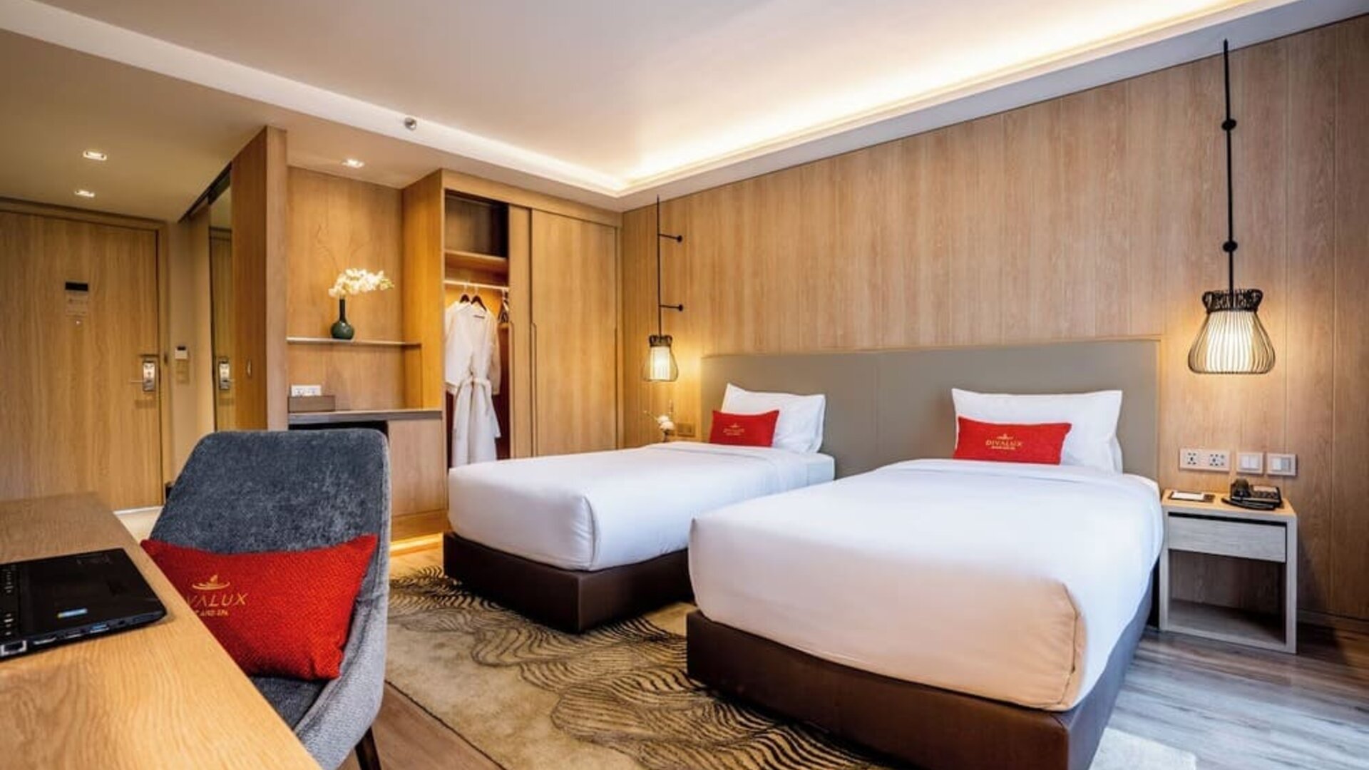 Day room with work desk and chair and natural light at Divalux Resort & Spa Bangkok Suvarnabhumi Airport.