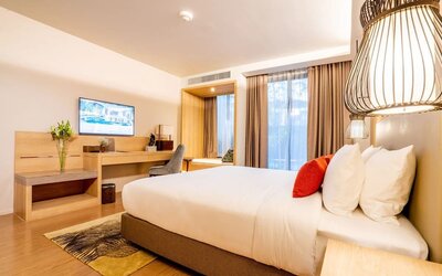 Day room with work desk and chair and natural light at Divalux Resort & Spa Bangkok Suvarnabhumi Airport.