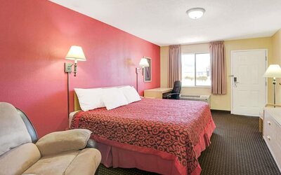 Day room with work desk and couch at Days Inn By Wyndham East Albuquerque.