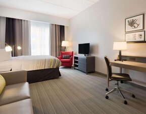 Day room with natural light and work space at Country Inn & Suites By Radisson, Katy - Houston West.