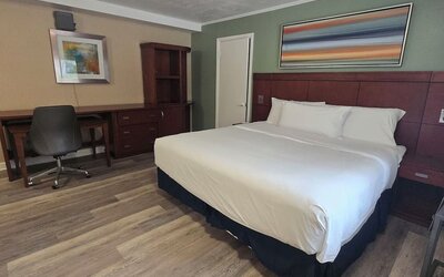 Spacious day room with desk and chair at Nashoba Valley Inn & Suit.